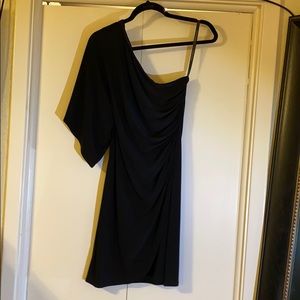 One shoulder black dress.